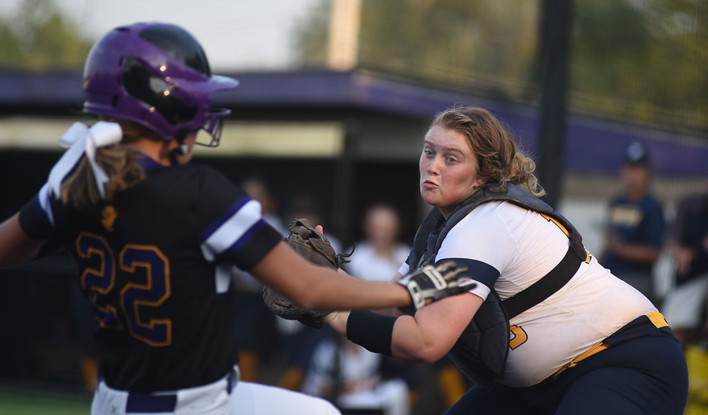 Battle catcher Sophia Fernandez moves to tag Hickman player Vera Grant as she runs into home plate